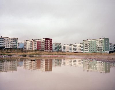 Apartment blocks reflected in water, Sakhalin Island, Far East Russia, October 2004
