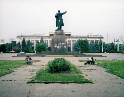 Two friends embrace behind Lenin, Volgograd, Volga, June 2005
